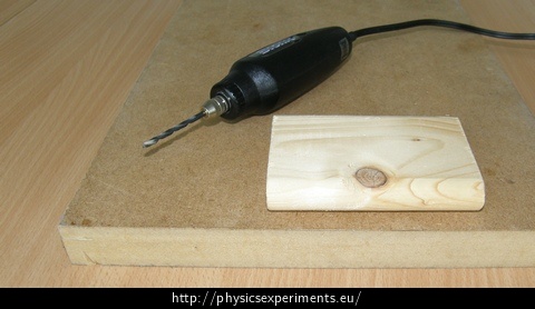Fig. 1: Illustrative image of tools: micro drill and wooden board with a solid wooden board underneath